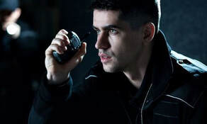 Unarmed security officer communicating via radio, emphasizing professional presence and security services in Florida.